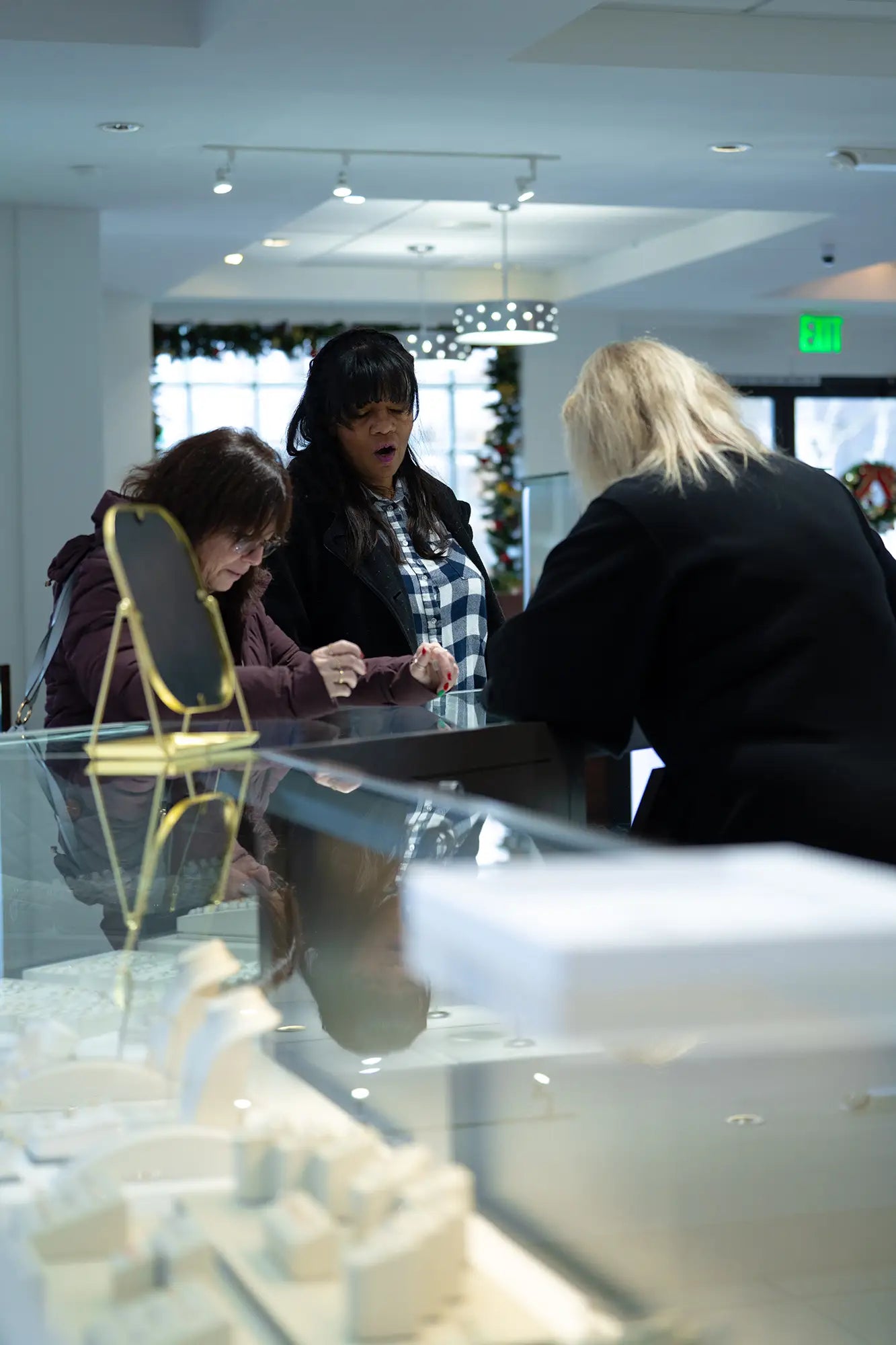 JosephK Jewelers store associate helping two customers