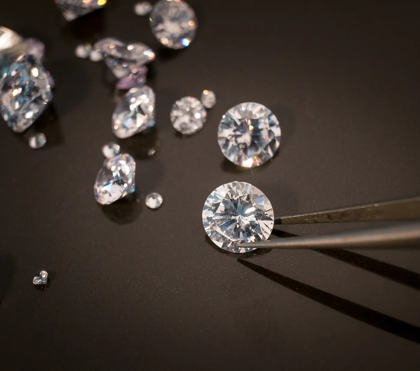 assorted loose diamonds on black background at JosephK Jewelers