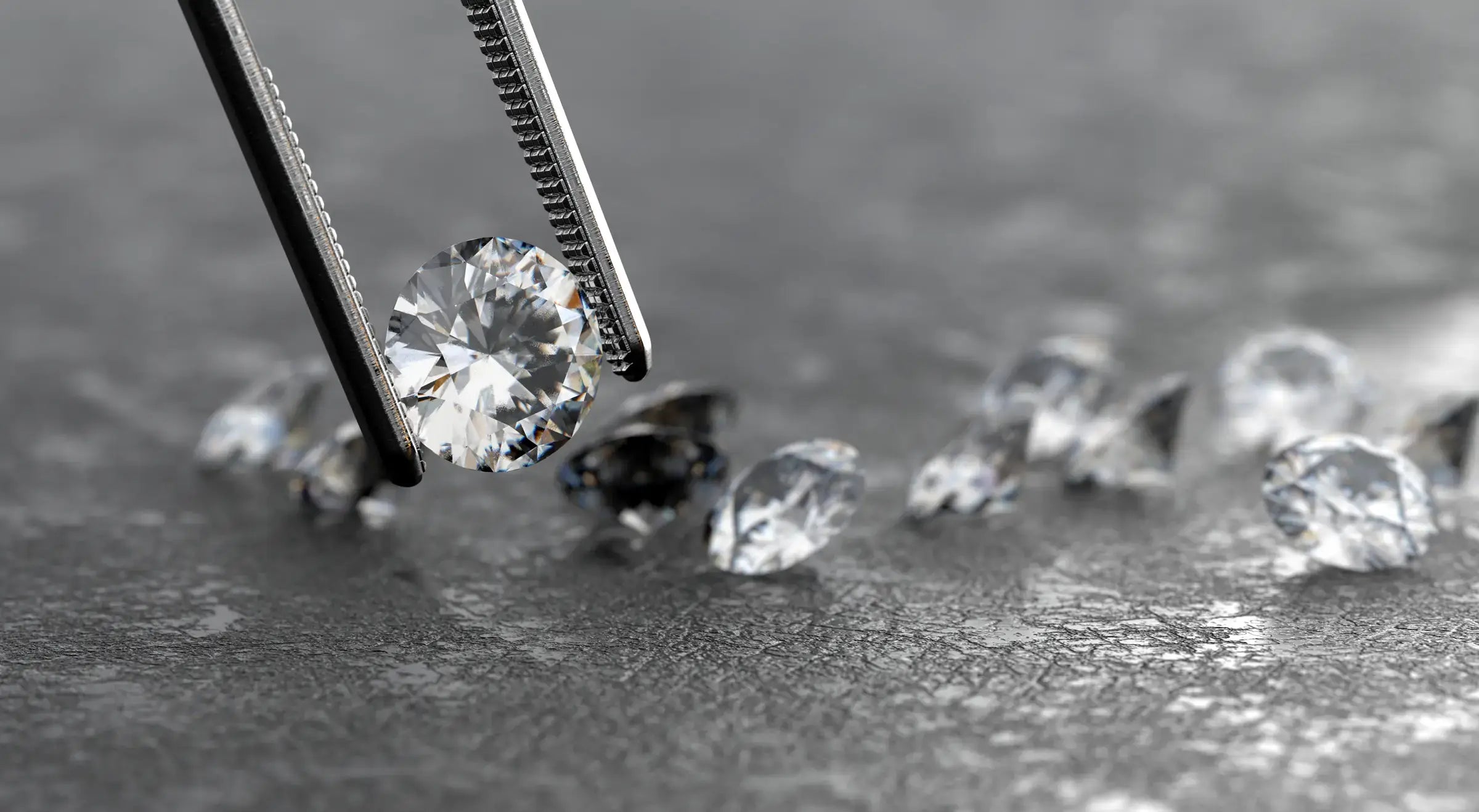 photo of loose diamonds being picked up with pliers at JosephK Jewelers