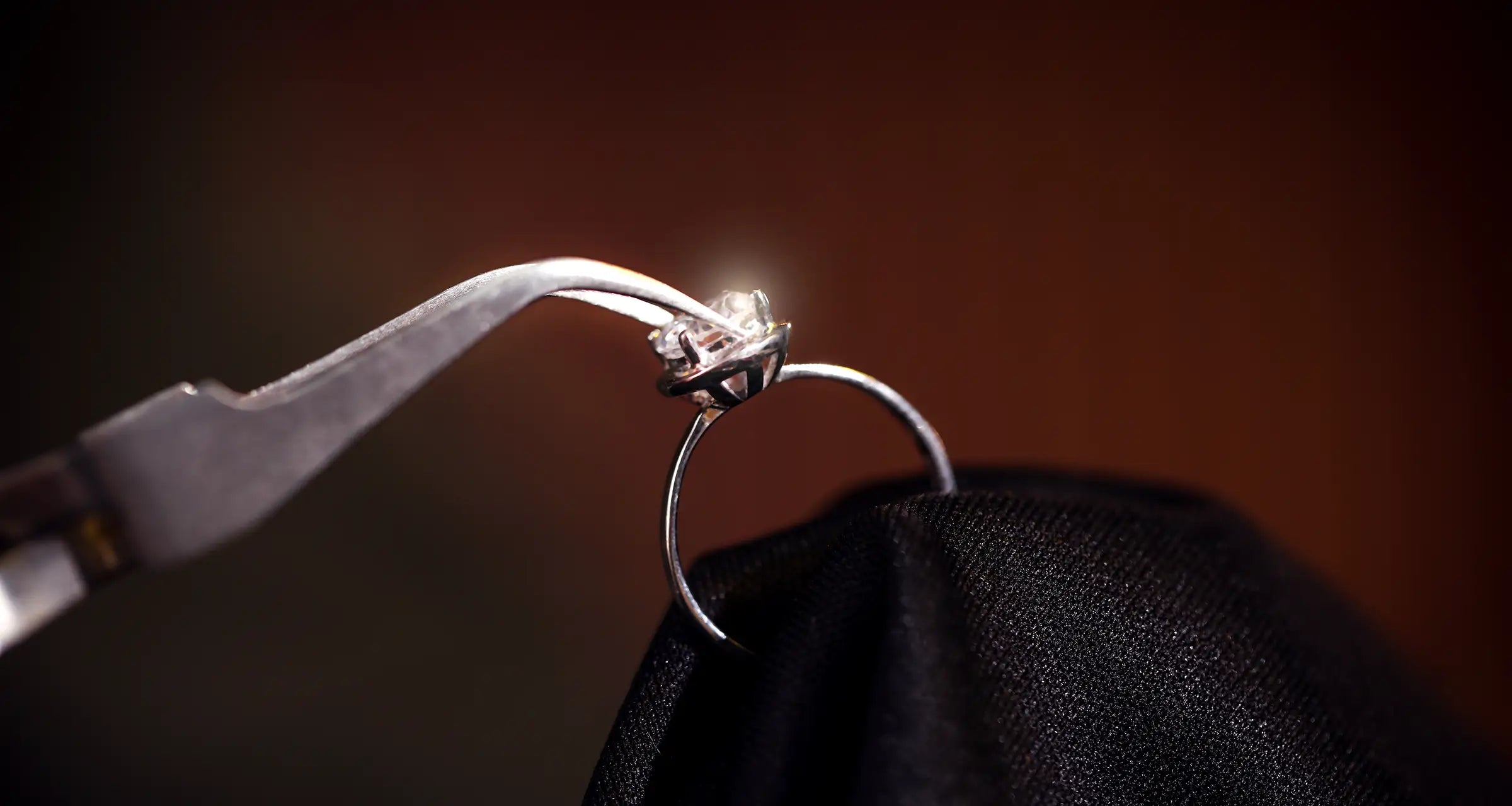 a diamond ring being repaired with pliers at JosephK Jewelers in Portland, OR