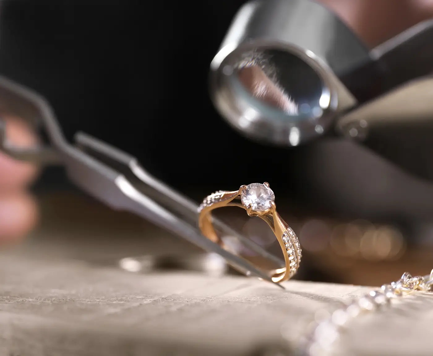 jeweler inspecting a gold diamond ring at JosephK Jewelers